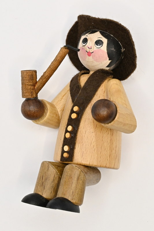 Large figure, man with hat and pipe, seated