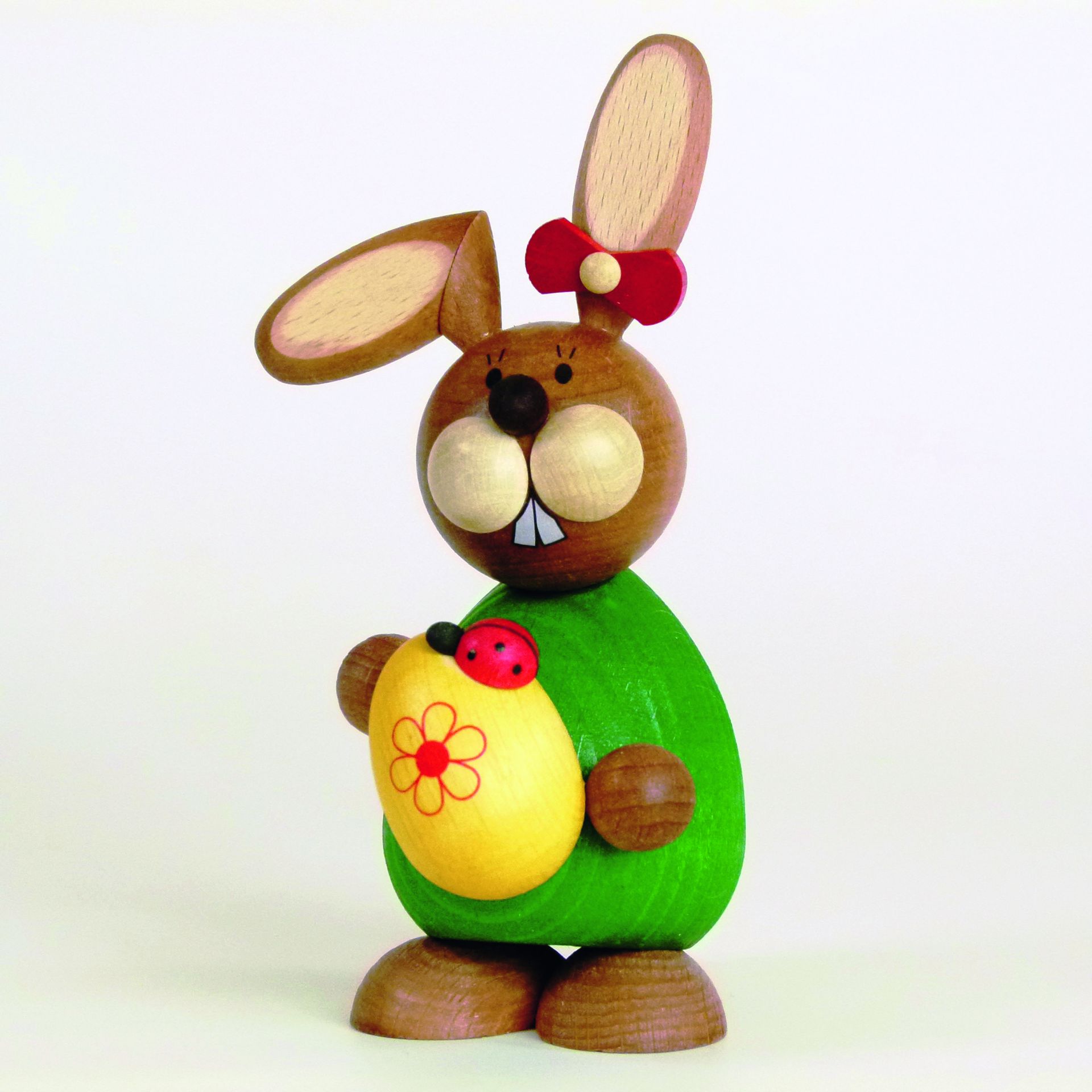 Easter bunny standing with yellow egg 5.5 cm x 12 cm (W x H)