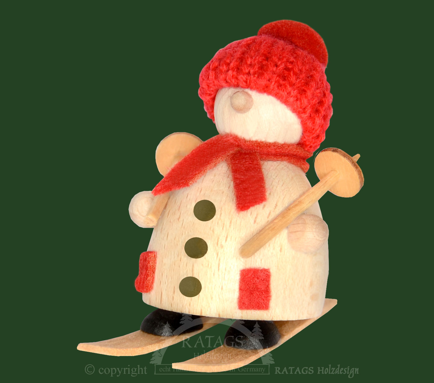 Snow-Molli auf Ski, rote Strickmütze