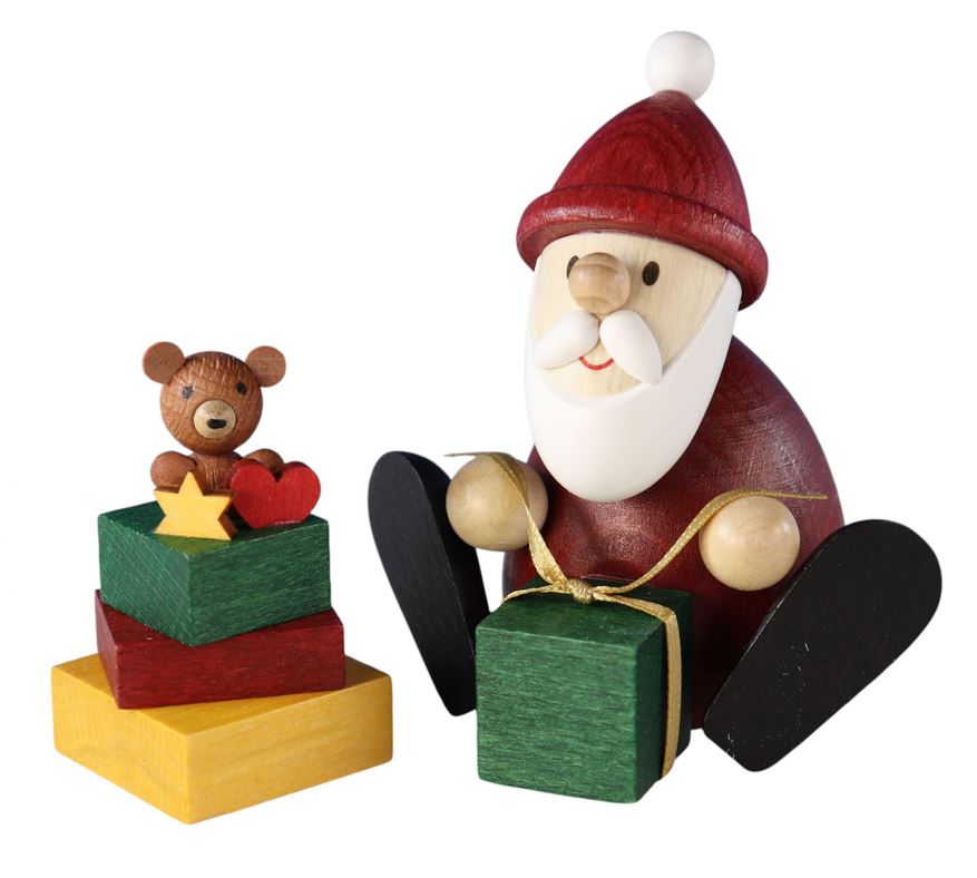 Weihnachtsmann mit Geschenk, Geschenkestapel
