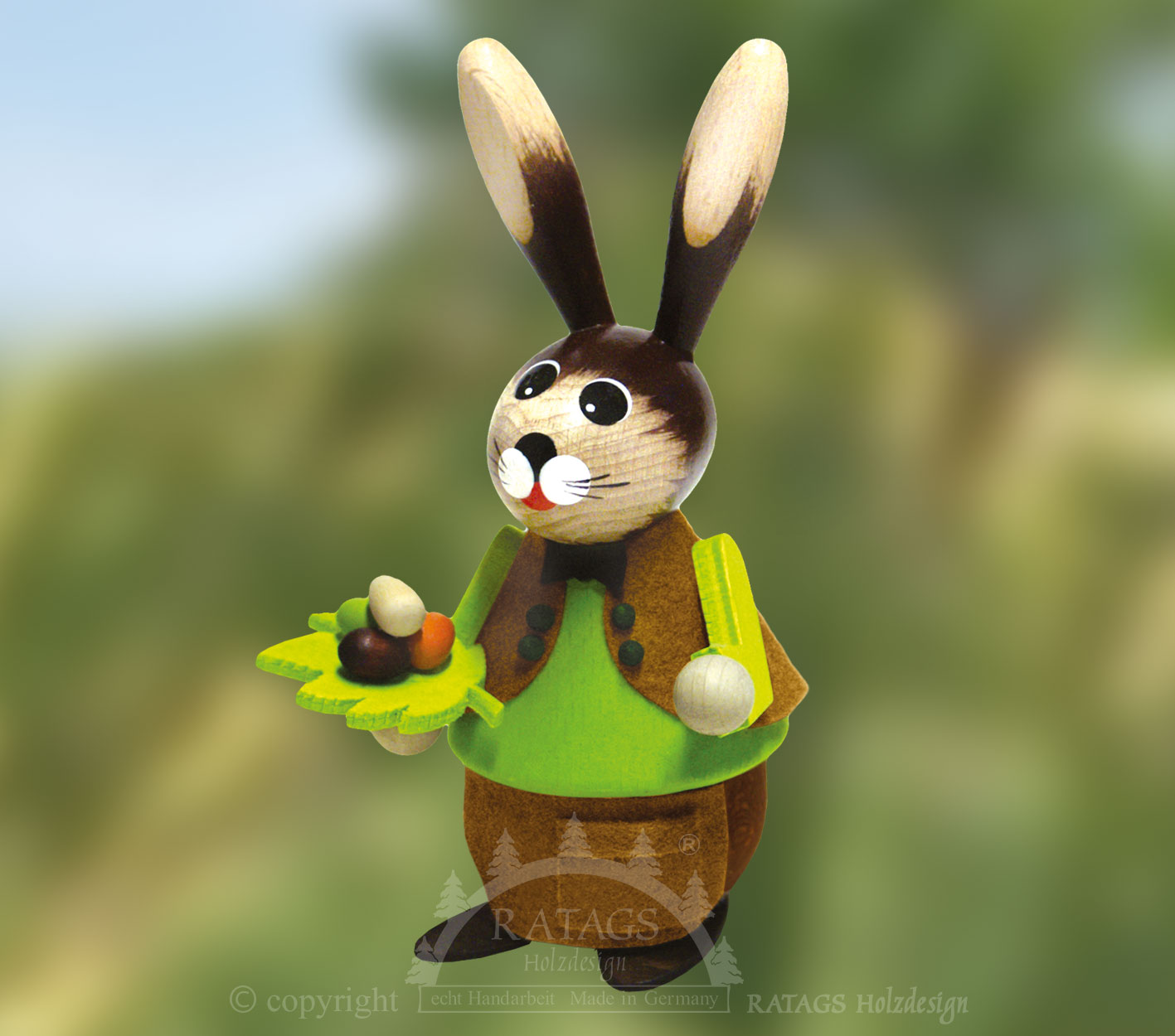 Cuddly rabbit with leaf and eggs