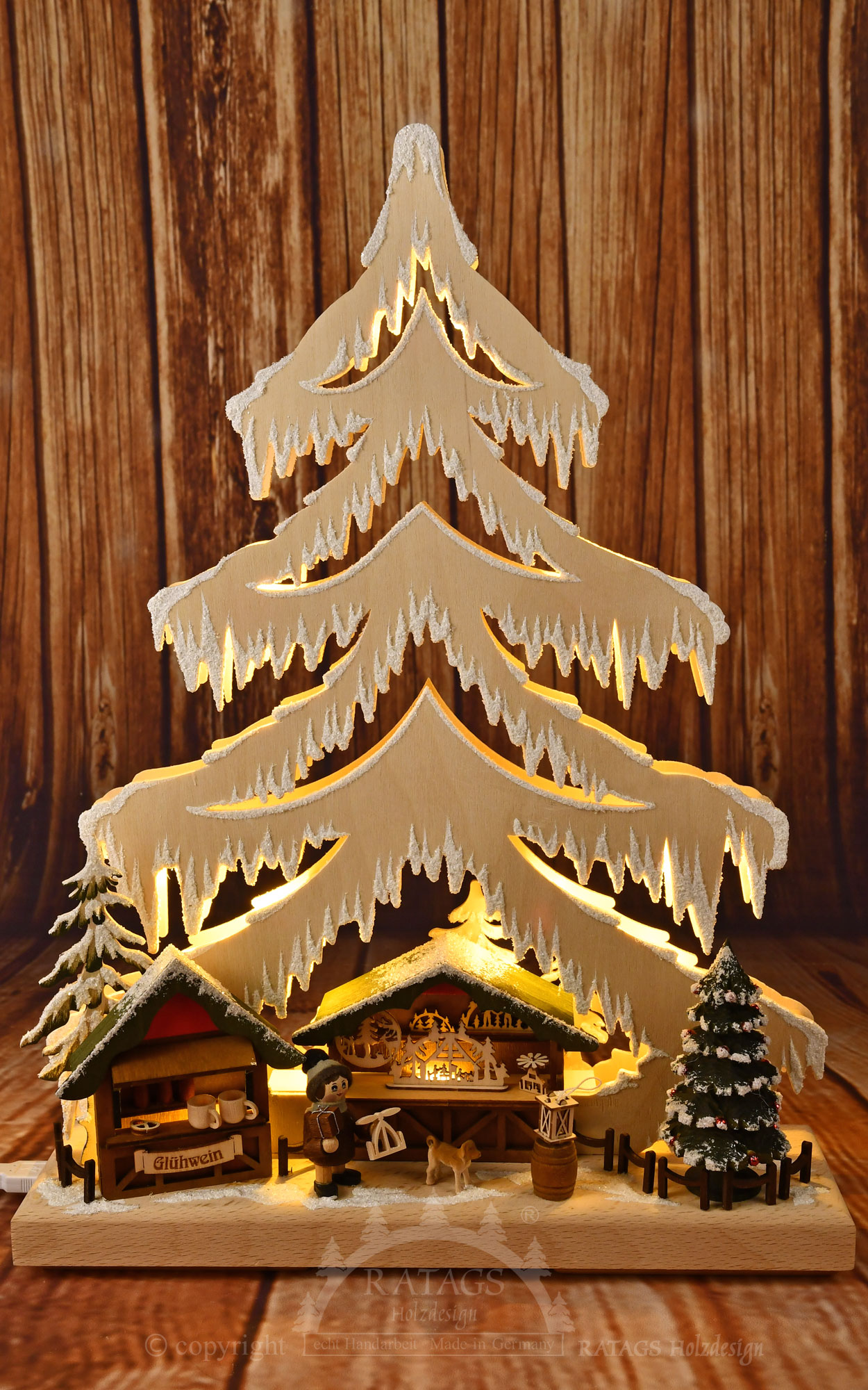 Small fir tree, Christmas market stalls, figure with dog